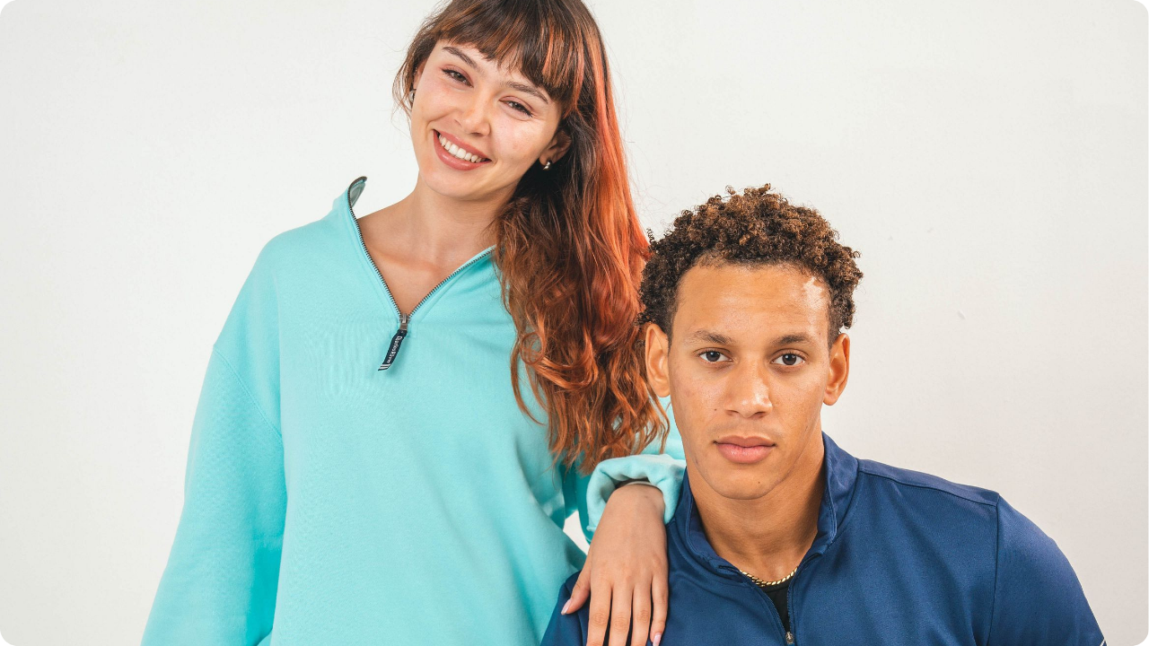 Guy and girl wearing q-zips