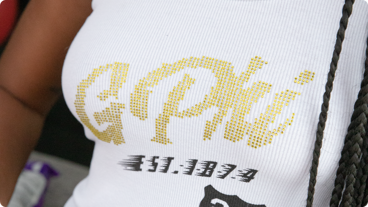 Gamma Phi gold rhinestones text design on ribbed tank top