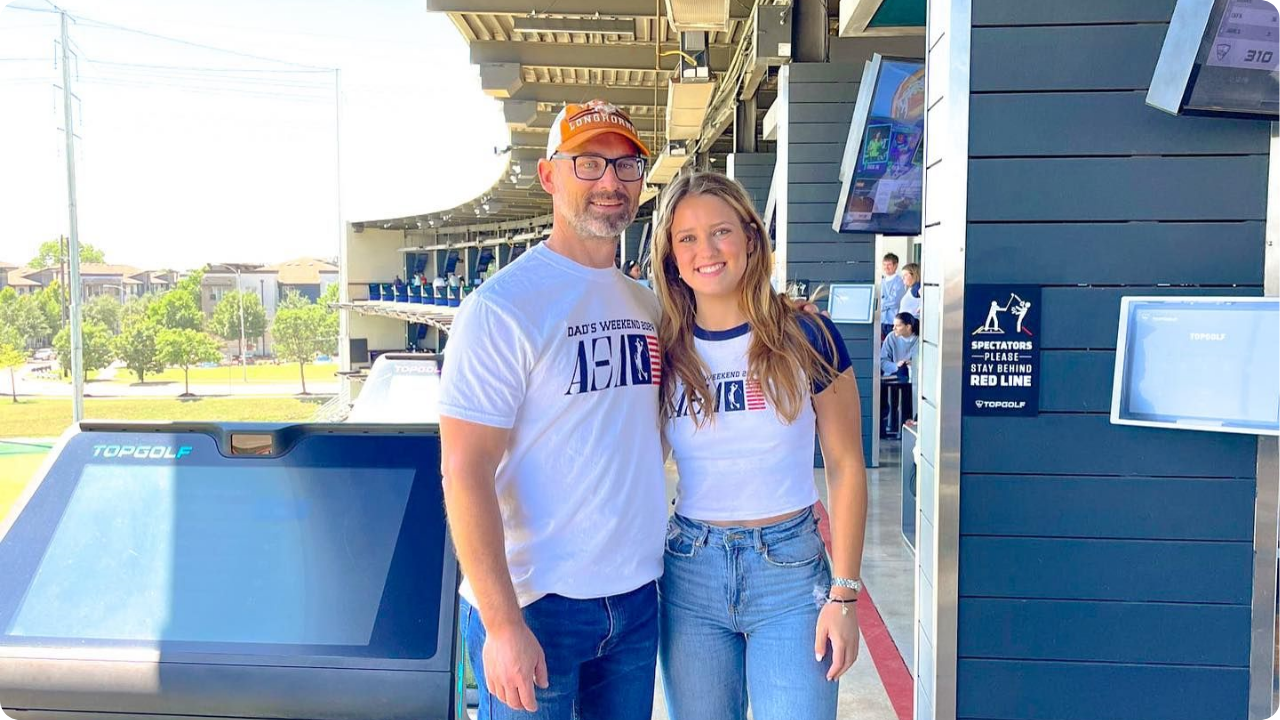 Father and Daughter wearing Alpha Xi Delta Dad's Weekend merch