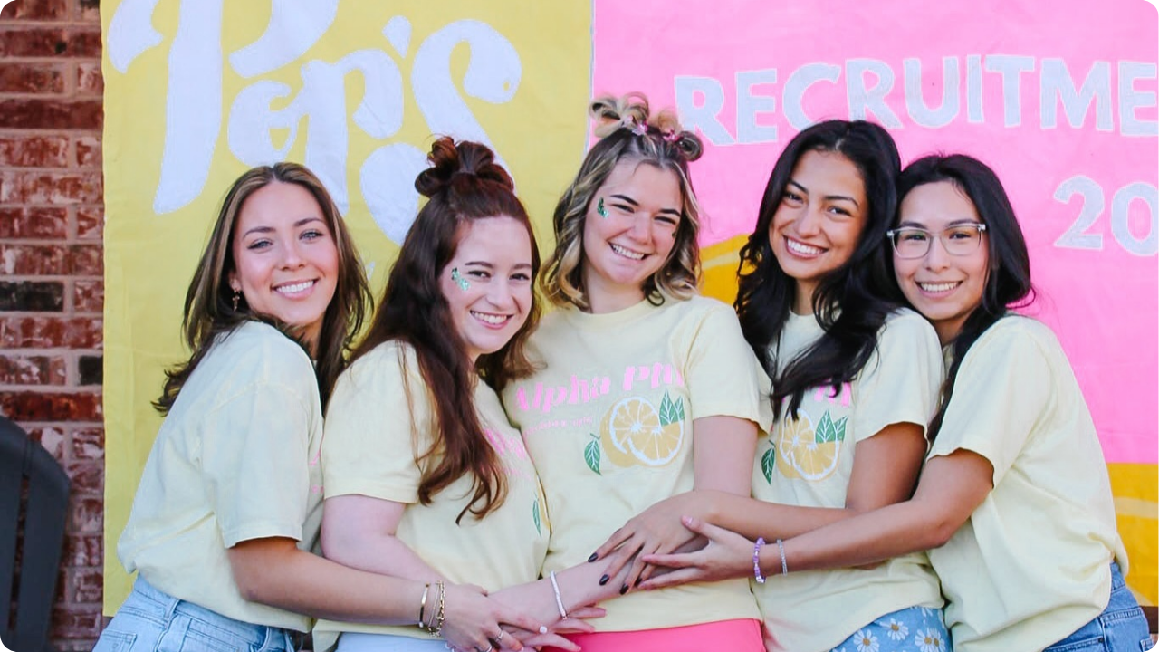 A group of girls wearing yellow Alpha Phi merch