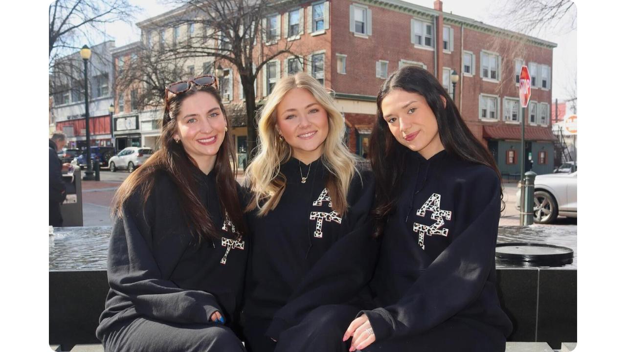 3 girls from Alpha Sigma Tau sorority wearing their custom black hoodie and sweatpants set