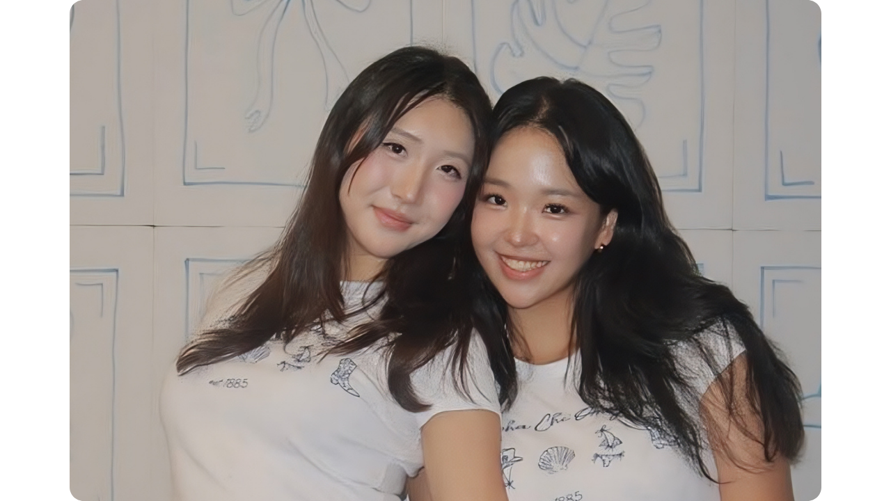 Two Alpha Chi Omega members wearing matching white shirts created by Fresh Prints