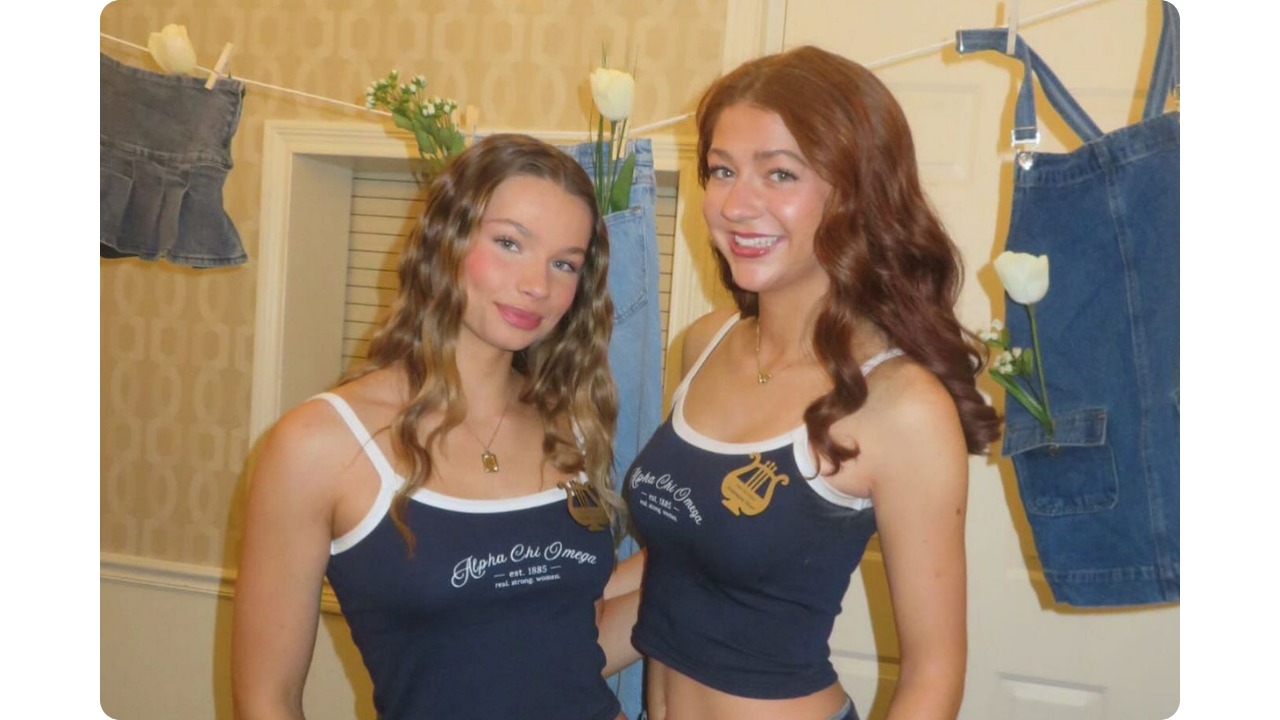 Two Alpha Chi Omega members wearing matching navy blue tank top merch with white straps created by Fresh Prints