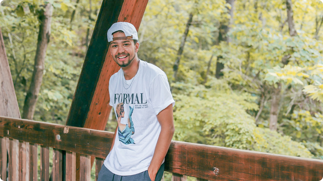 Photo of a guy wearing custom merch and facing the camera