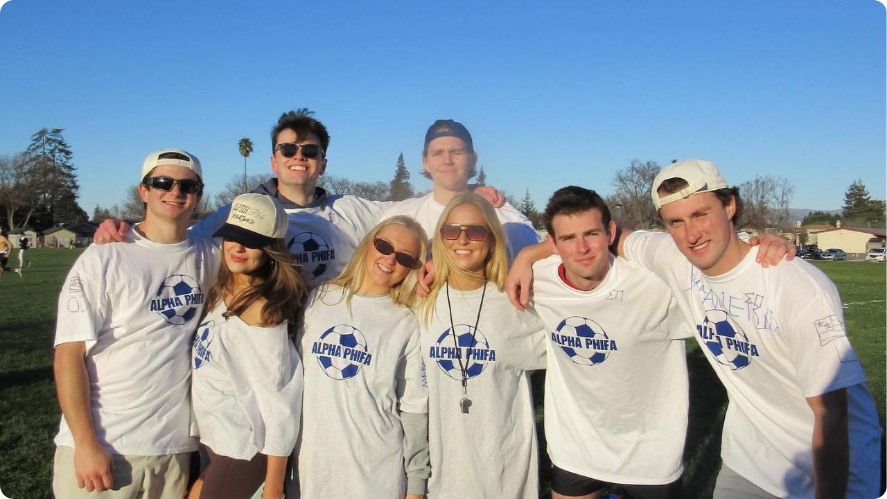 Group of college students wearing white custom shirts with blue print.