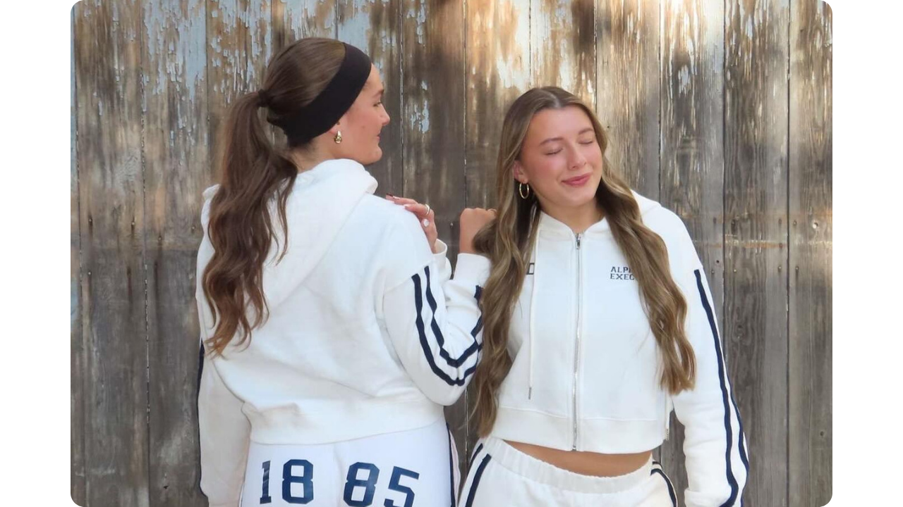 Two members of Alpha Chi Omega's executive board wearing matching sporty sweat sets created by Fresh Prints