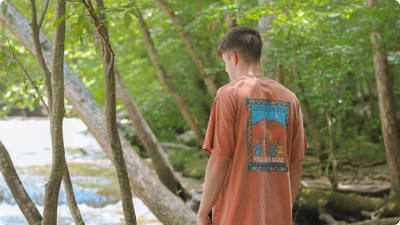 Photo of a guy wearing a custom shirt looking away from the camera